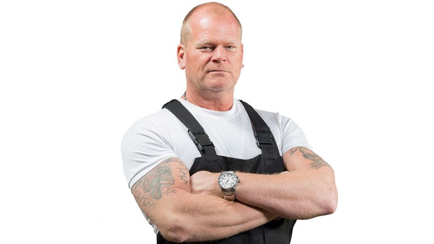 Mike Holmes posing in contractor outfit