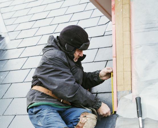 a man fixing shingles