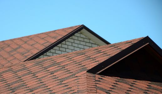 Hero New red bitumen shingles on a light blue sky