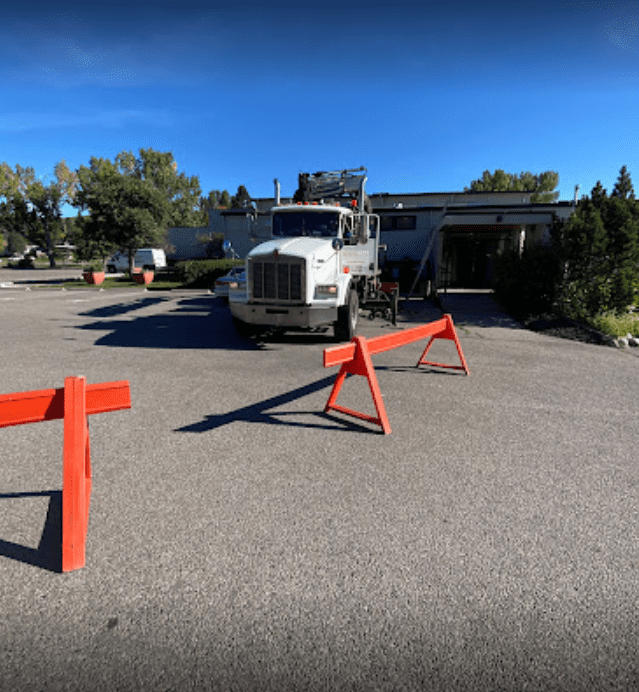 a truck unloading roofing products on a commercial jobsite