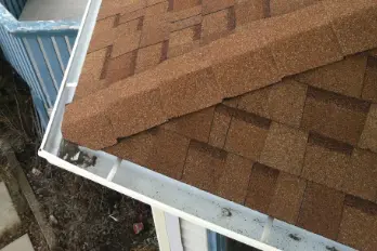 aerial view of a gutter next to shingles