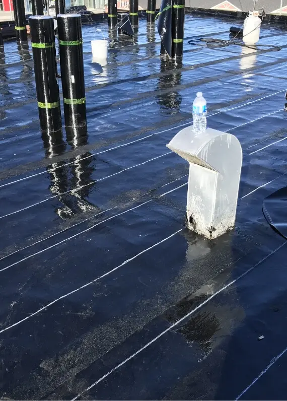 layers of freshly added SBS flat roof product on a roof