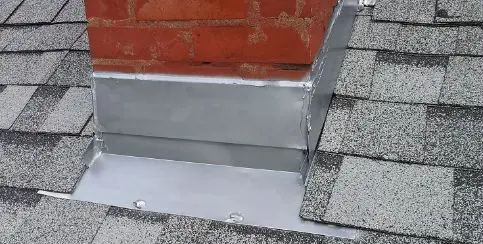 metal step flashing installed on a brick chimney