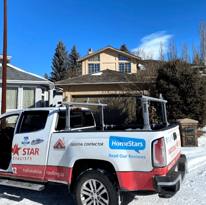 a truck parked infront of a house in Edmonton carrying roofers to re-roof the house