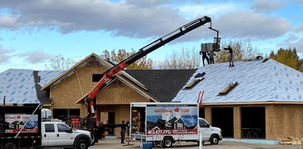 roofers in Edmonton loading shingles on a roof